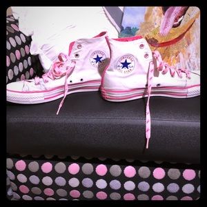 A pair of true classic HIGH TOP CONVERSE SNEAKERS